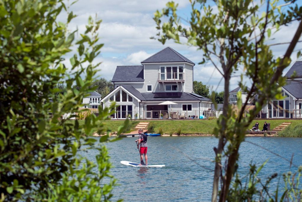 Man Paddleboarding on Cotswold Lake